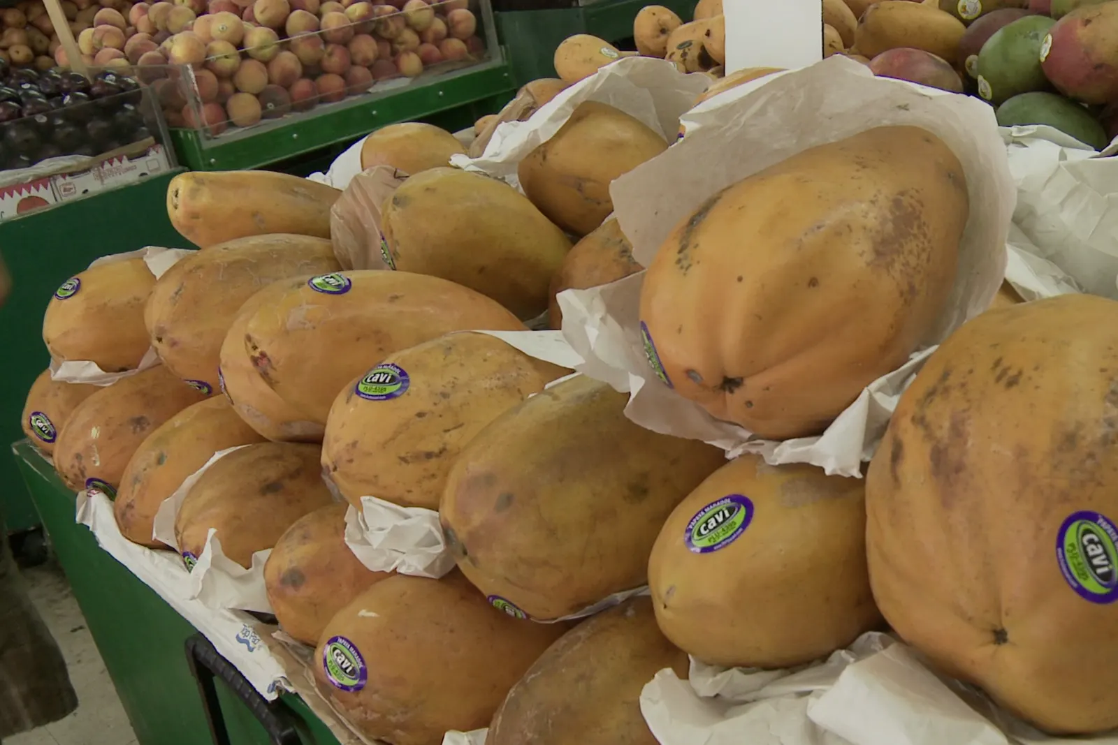 Papayas and mangoes on a market stand