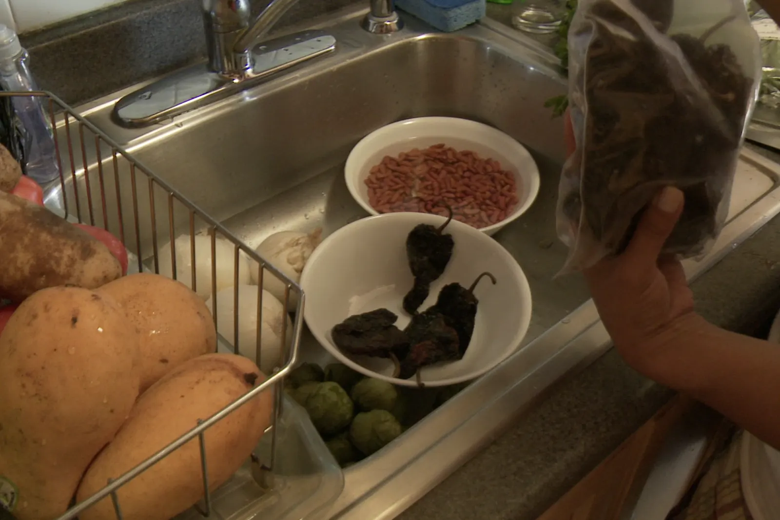 Produce and dried chiles resting at the kitchen sink